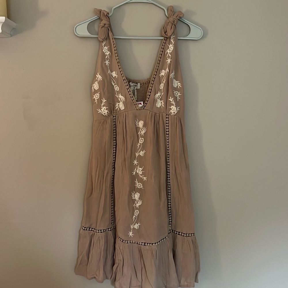 tan embroidered sun dress with tie straps, flowy, falls above the knee